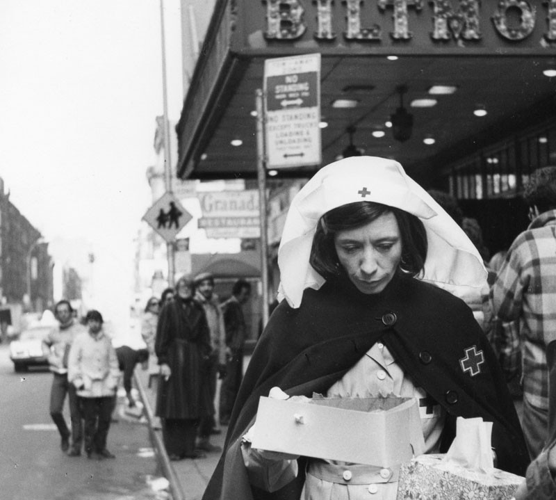 Lily Tomlin as “Red Cross Worker”. Handing out coffee and donuts to fans waiting in line to buy tickets to “Appearing Nitely” at the Biltmore. Young Judith Beasley “Stay Put” hair commercial from Emmy award winning special.  © 2015 Lily Tomlin. All Rights Reserved.