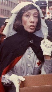 Lily Tomlin as "Red Cross Worker". Handing out coffee and donuts to fans waiting in line to buy tickets to "Appearing Nitely" at the Biltmore. Young Judith Beasley "Stay Put" hair commercial from Emmy award winning special. © 2015 Lily Tomlin. All Rights Reserved.